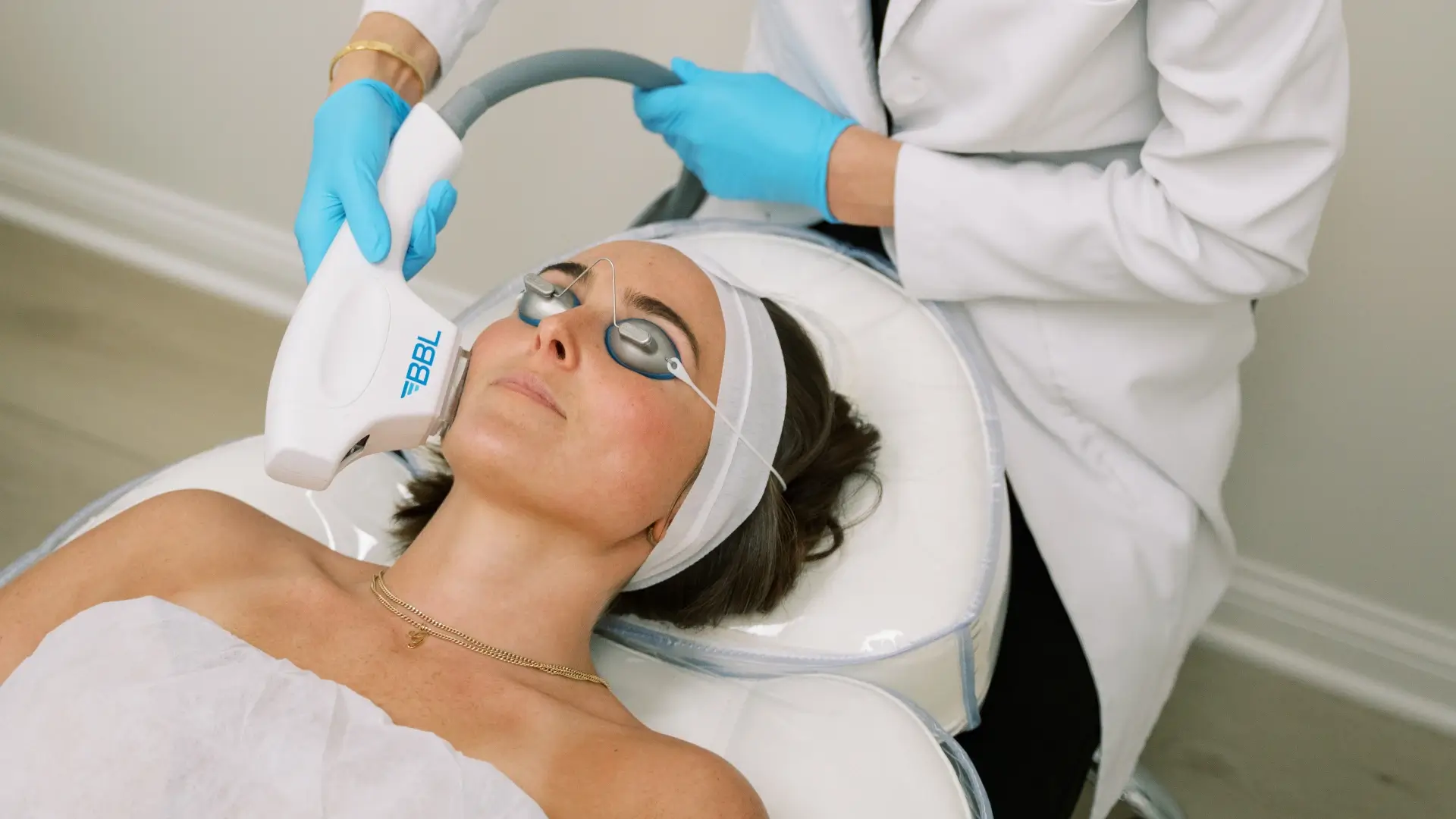 Aesthetic specialist performing BBL laser treatment for skin rejuvenation.