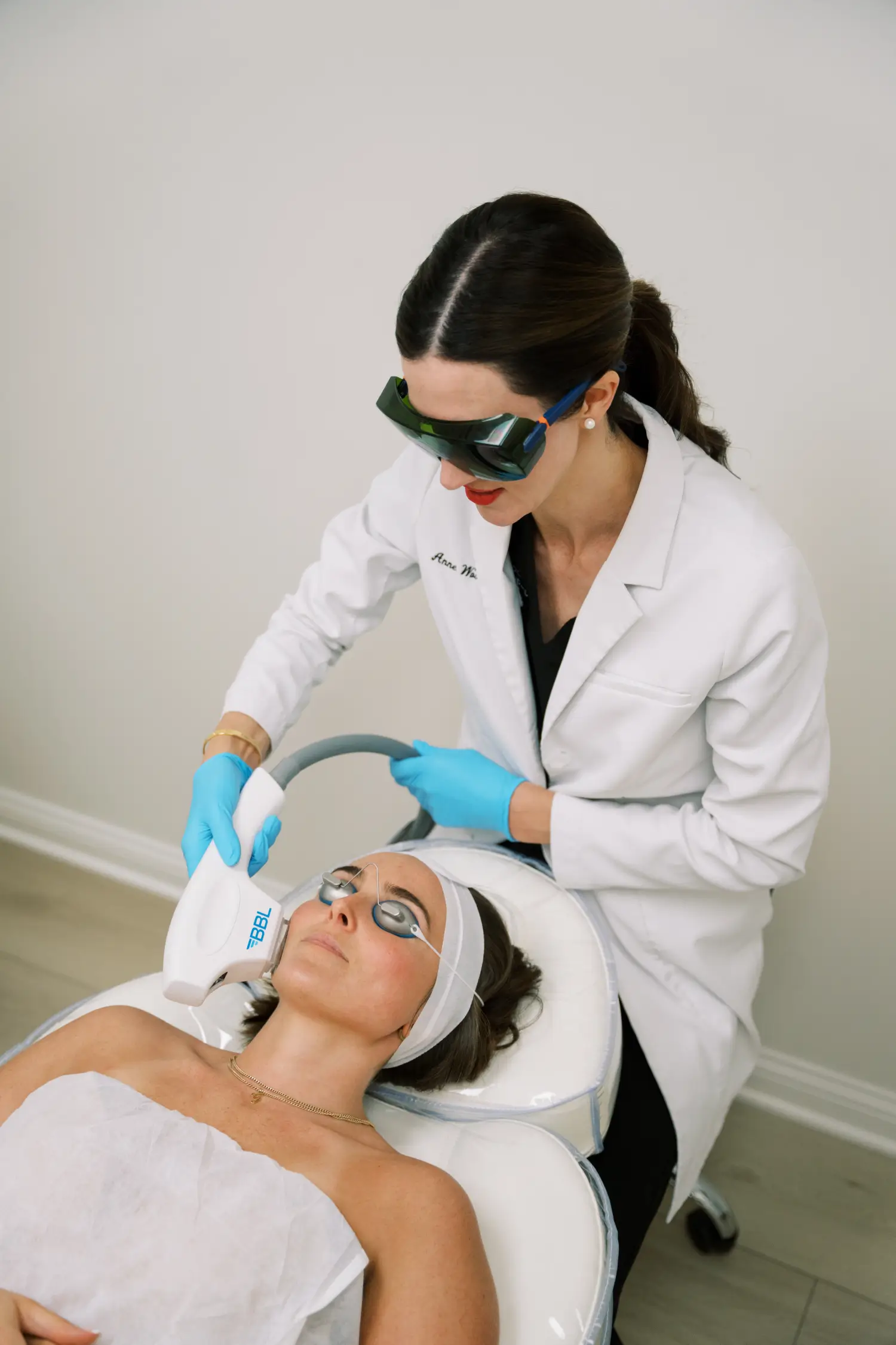 Aesthetic specialist performing BBL laser treatment for skin rejuvenation.