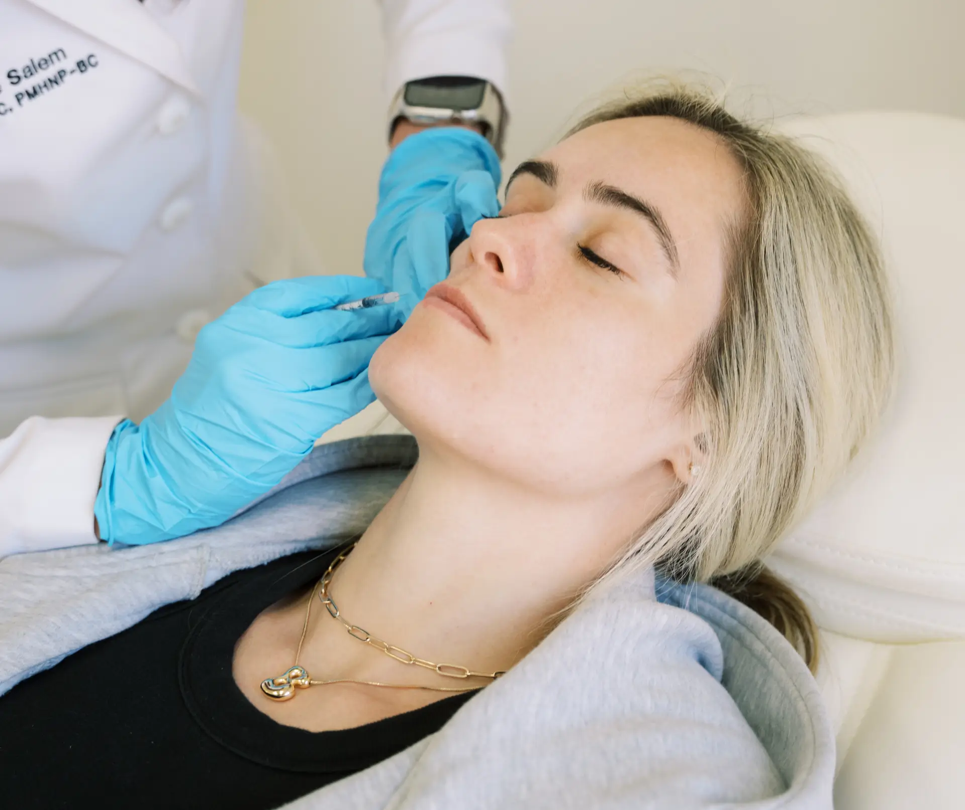 Medical professional administering cosmetic injectables for facial rejuvenation.