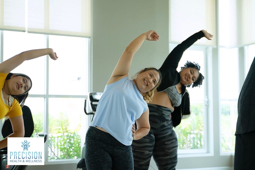 Women stretching in fitness class to optimize hormone balance and wellness.