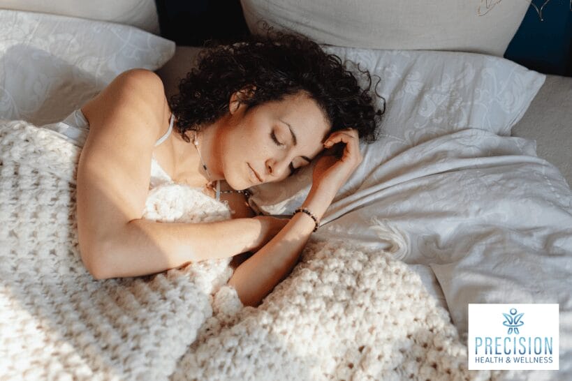 Beautiful woman sleeping peacefully in bed to restore hormones and improve weight loss